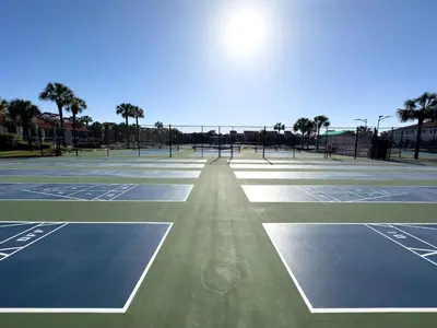 an empty tennis court with the sun shining on it at Edgewater Villa 2205 'Turtle Dunes' in Panama City Beach