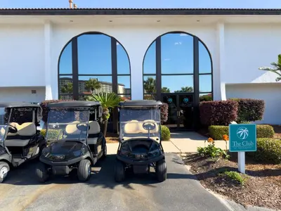three golf carts parked in front of a building at Edgewater Villa 2205 'Turtle Dunes' in Panama City Beach