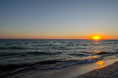 a sunset on the beach with the ocean at Commodore 1309 'Paradise Pass' in Panama City Beach