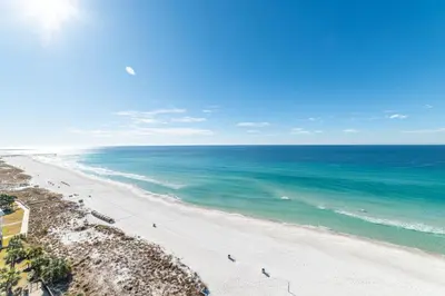 an aerial view of a beach with people in the water at Commodore 1309 'Paradise Pass' in Panama City Beach