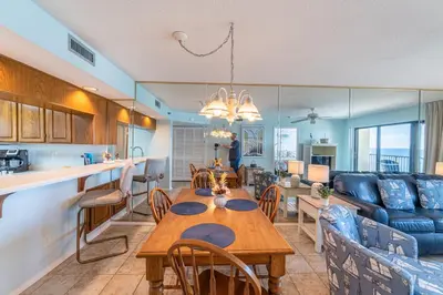 a kitchen and living room with a table and a couch at Commodore 1309 'Paradise Pass' in Panama City Beach