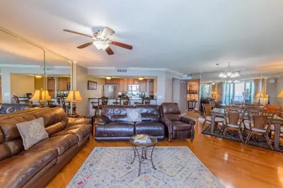 a living room with a leather couch and a table at Dunes of Panama E1703 'After-Dune Delight' in Panama City Beach