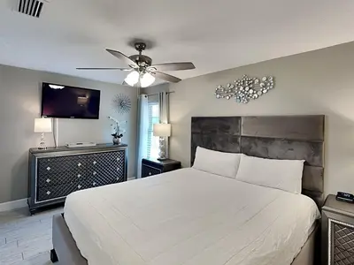 a bedroom with a white bed and a ceiling fan at Horizon South #57-203 in Panama City Beach