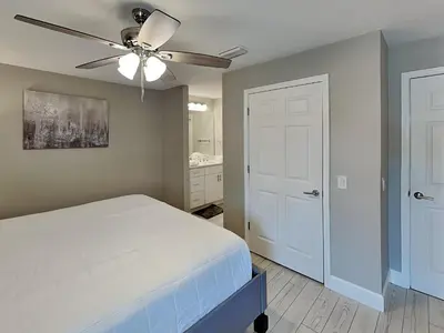 a bedroom with a bed and a ceiling fan at Horizon South #57-203 in Panama City Beach