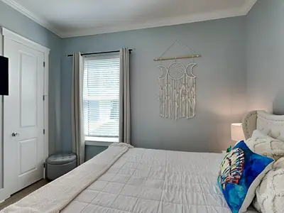 a bedroom with a large bed and a window at The Blue Pearls in Panama City Beach