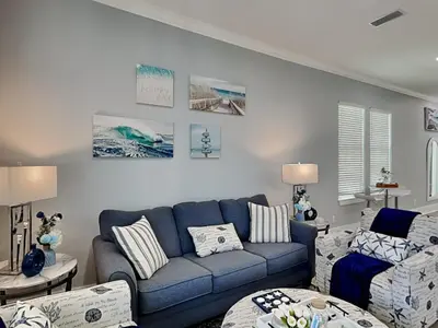 a living room with a blue couch and chairs at The Blue Pearls in Panama City Beach