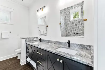 a bathroom with a sink and a mirror at 30Yay! by 30A Escapes in Watersound Beach