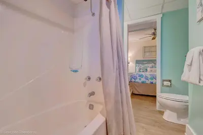 a bathroom with a bath tub and a toilet at Sunbird Resort Ground Floor Gem with Ocean Views! Free Beach Chairs and Umbrella! by Dolce Vita Getaways PCB in Panama City Beach