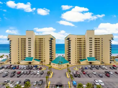 an aerial view of a parking lot at a resort at Sunbird Resort Ground Floor Gem with Ocean Views! Free Beach Chairs and Umbrella! by Dolce Vita Getaways PCB in Panama City Beach
