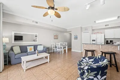 a living room with a couch and a table at Tidewater Beach Resort #1110 by Book That Condo in Panama City Beach