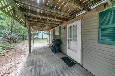 a porch of a house with a door and a bench at Beach Haven by Emerald Coast Retreats in Panama City Beach