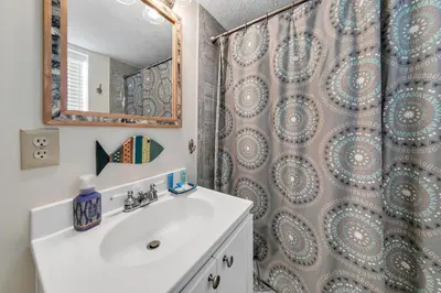 a bathroom with a sink and a shower at Beach Haven by Emerald Coast Retreats in Panama City Beach