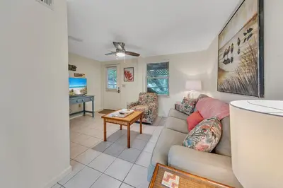 a living room with a couch and a table at Beach Haven by Emerald Coast Retreats in Panama City Beach