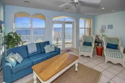 a living room with a blue couch and a table at Monterey C-201 in Seacrest