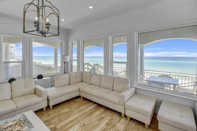 a living room with white furniture and large windows at Ocean Front Property in Seacrest