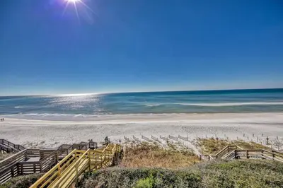 a beach with stairs leading down to the beach at Ocean Front Property in Seacrest