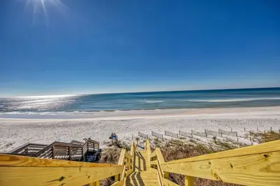 a view of a beach with a wooden stairway at Ocean Front Property in Seacrest