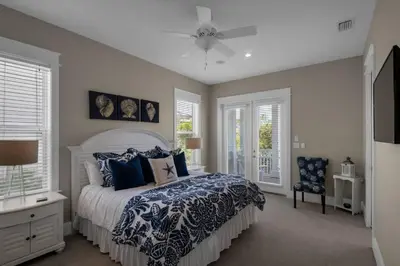 a bedroom with a bed and a ceiling fan at Wine Down 30A in Seacrest