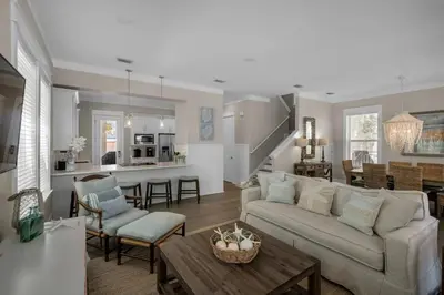 a living room and kitchen with a couch and a table at Wine Down 30A in Seacrest