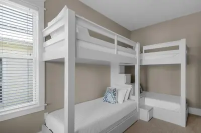 a bedroom with two bunk beds and a window at Wine Down 30A in Seacrest