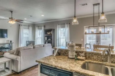 a kitchen and living room with a couch and a sink at Here & Now in Inlet Beach