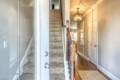 a staircase in a home with a glass door at Here & Now in Inlet Beach