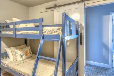 a bunk bed room with two bunk beds and a ladder at Here & Now in Inlet Beach