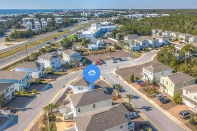 an aerial view of a residential neighbourhood with a blue google sign at Here & Now in Inlet Beach