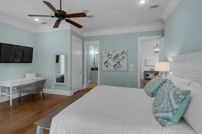 a bedroom with a bed and a desk and a ceiling fan at Scout's Lookout in Inlet Beach