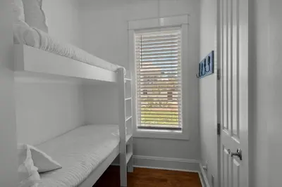 a bedroom with a bunk bed and a window at Scout's Lookout in Inlet Beach