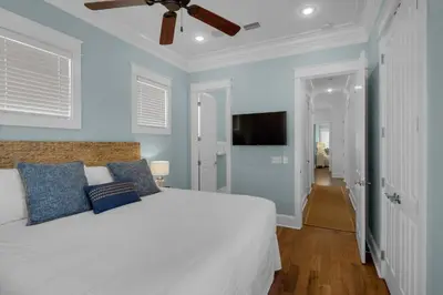 a bedroom with a white bed and a ceiling fan at Scout's Lookout in Inlet Beach