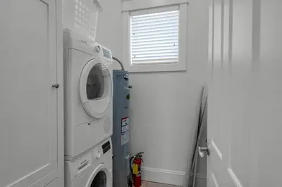 a laundry room with a washing machine and a window at Scout's Lookout in Inlet Beach