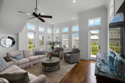 a living room with a couch and chairs and windows at Scout's Lookout in Inlet Beach