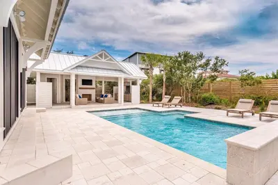 a swimming pool in the backyard of a house at Paradise Found 30A in Seacrest