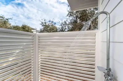 a shower in a privacy fence with a hose at Paradise Found 30A in Seacrest