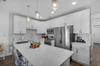 a kitchen with white cabinets and a white counter top at Feeling Tip Sea in Santa Rosa Beach