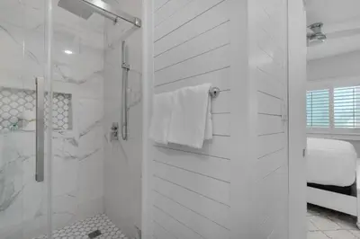 a white bathroom with a shower and a shower at Feeling Tip Sea in Santa Rosa Beach