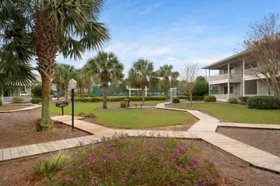 a park with palm trees and a building at Beachwood Villas 7G in Santa Rosa Beach