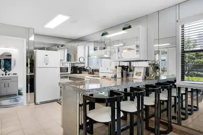 a kitchen with a counter with bar stools at Beachwood Villas 7G in Santa Rosa Beach