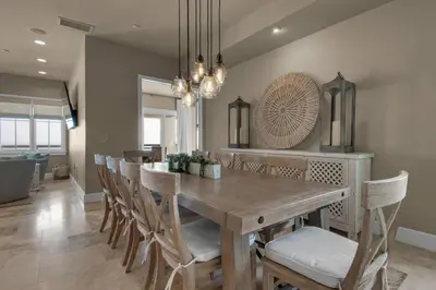 a dining room with a wooden table and chairs at The Penthouse at Seagrove in Santa Rosa Beach