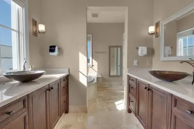a bathroom with two sinks and a toilet at The Penthouse at Seagrove in Santa Rosa Beach