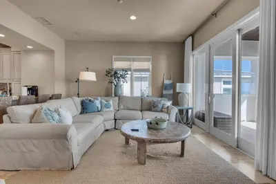 a living room with a couch and a table at The Penthouse at Seagrove in Santa Rosa Beach