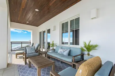 a living room with a couch and chairs and a table at The Penthouse at Seagrove in Santa Rosa Beach