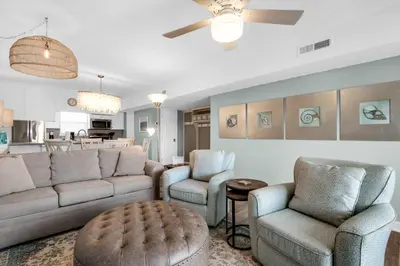 a living room with a couch and two chairs at Cloud Nine By the Sea in Inlet Beach