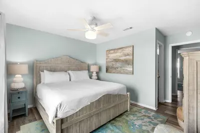 a bedroom with a bed and a ceiling fan at Cloud Nine By the Sea in Inlet Beach
