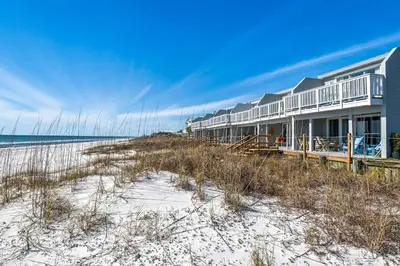 a house on the beach next to the ocean at Cloud Nine By the Sea in Inlet Beach