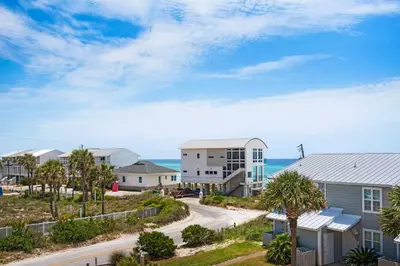 a view of a street with houses and the ocean at Cloud Nine By the Sea in Inlet Beach