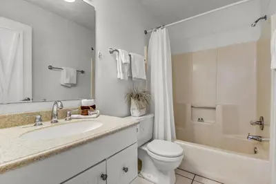 a bathroom with a sink and a toilet and a tub at Beachside 10 in Santa Rosa Beach