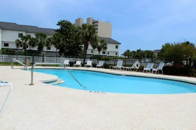 a large swimming pool with chairs at Beachside 10 in Santa Rosa Beach