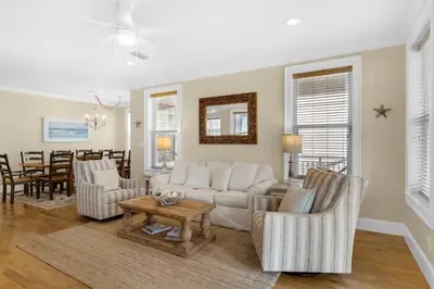 a living room with a couch and chairs and a table at Palms and Pines in Rosemary Beach
